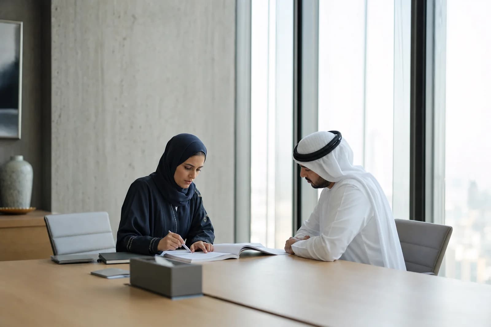 Dubai ISR Compliance Consulting Company Consultants reviewing Dubai ISR control documentation with a client in a Dubai office