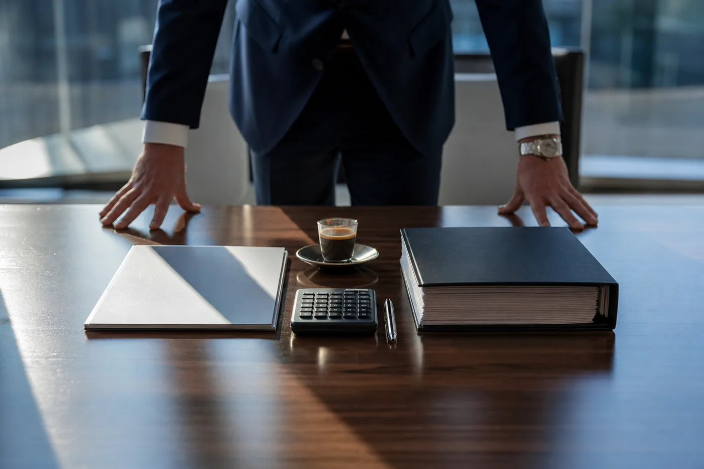 Slim quote and thick proposal side by side on a boardroom table
