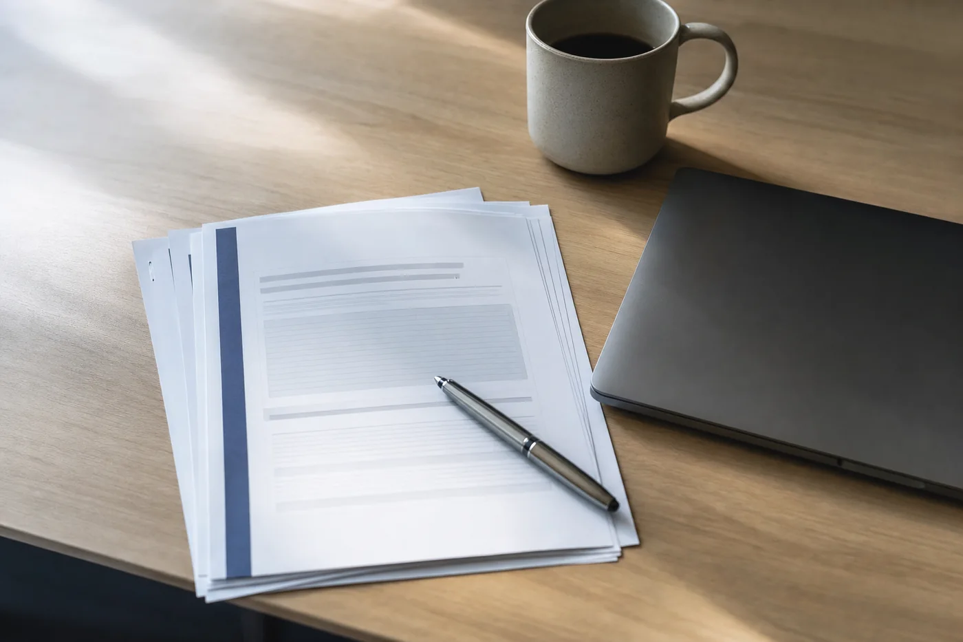 A vendor security questionnaire on a desk beside a closed laptop