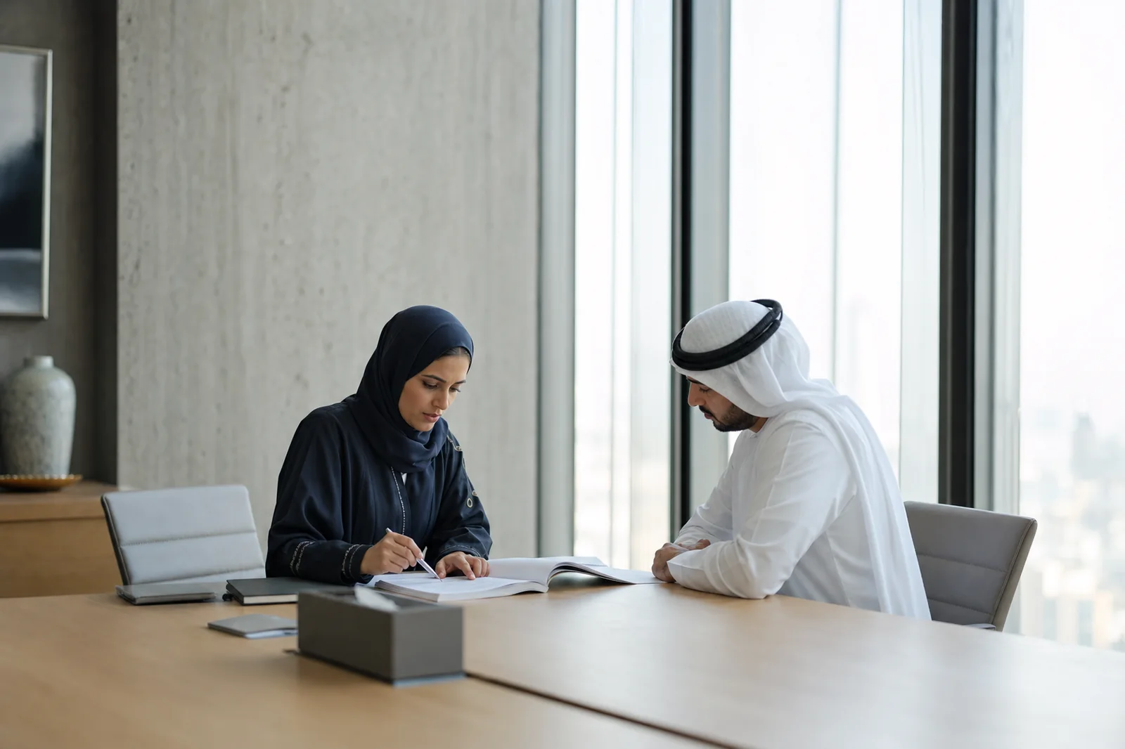 Dubai ISR Compliance Consulting Company Consultants reviewing Dubai ISR control documentation with a client in a Dubai office